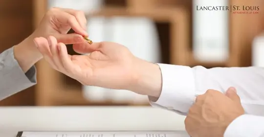 A person hands over a wedding ring